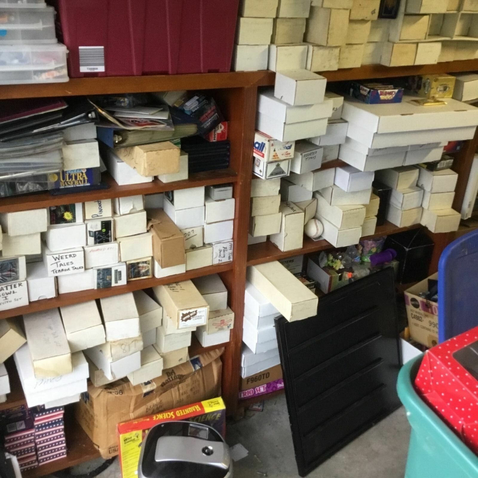 Wall of shelves packed with hundreds of sports card storage boxes